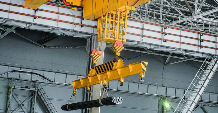 Industrial lifting devices in action, safely moving heavy materials in a warehouse setting.